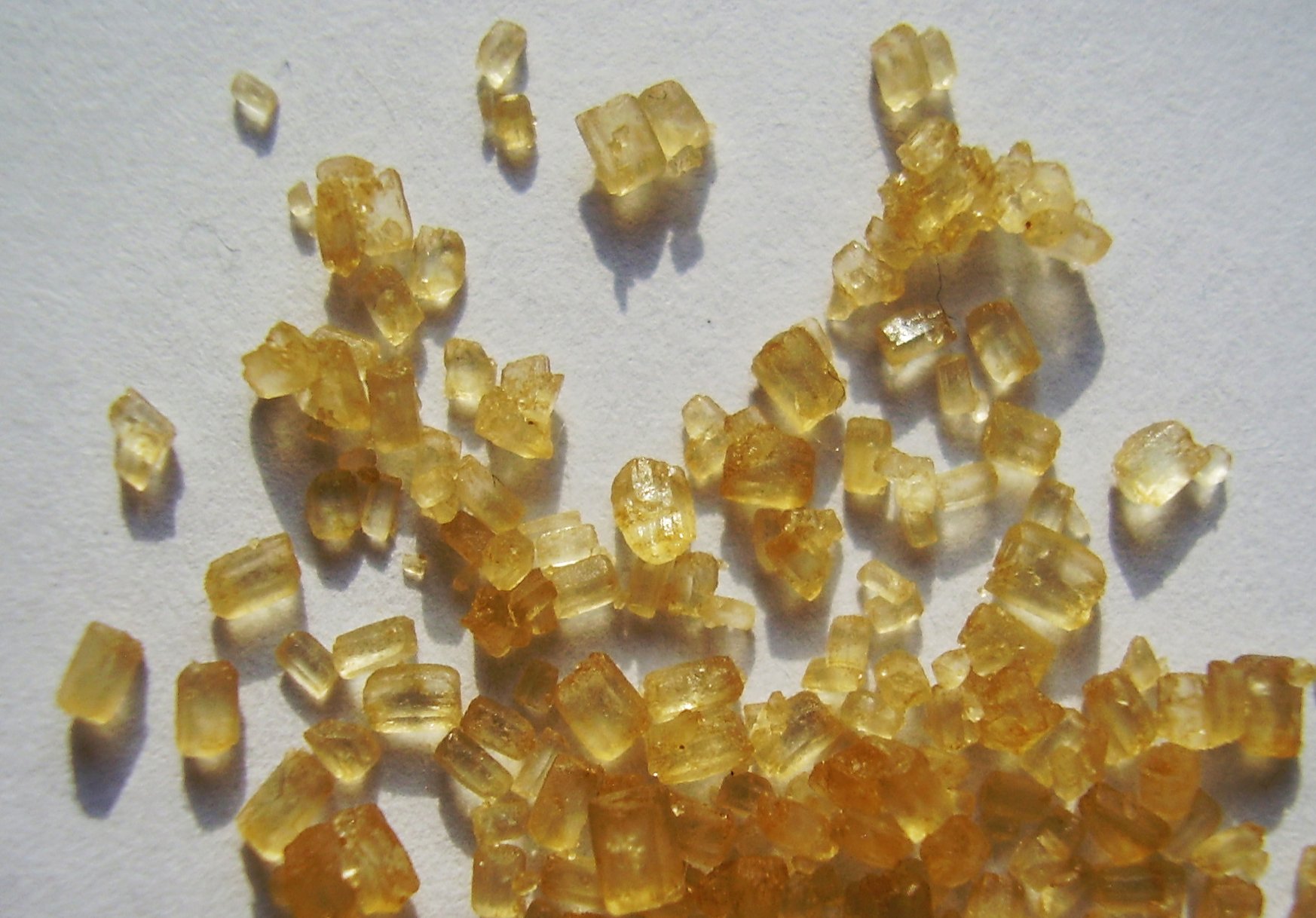 Close-up of brown sugar crystals in sunlight